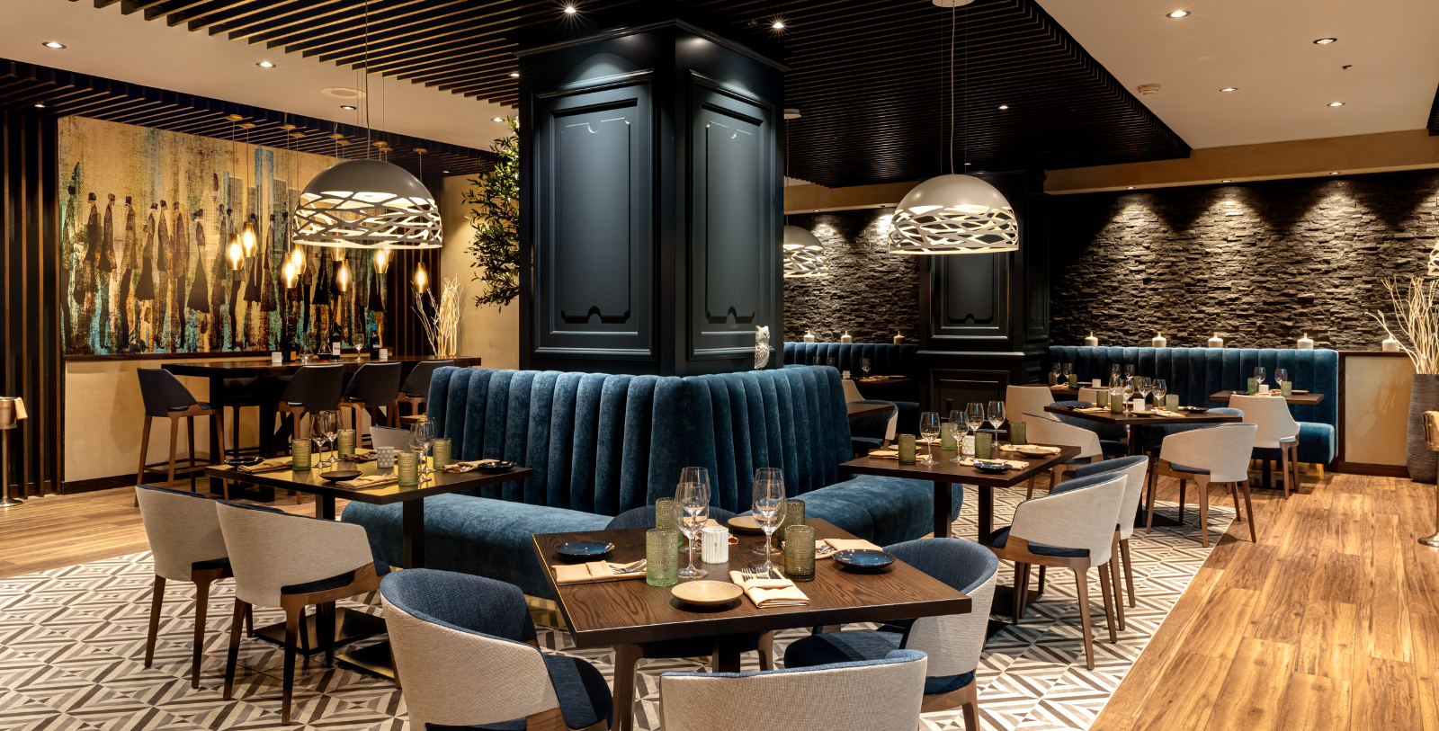a restaurant with blue couches and tables