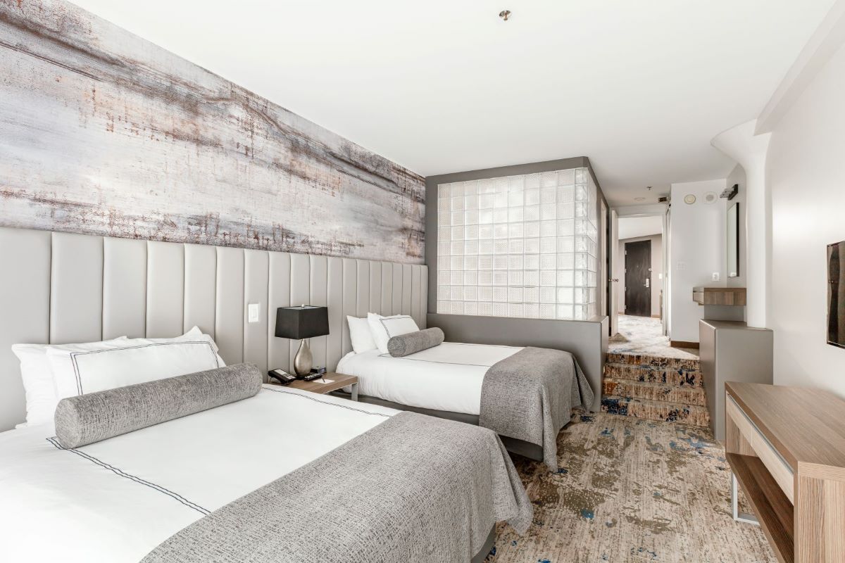 a room with two beds and a carpeted floor