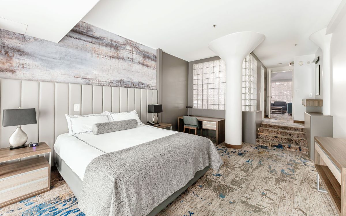 a room with a bed and stairs