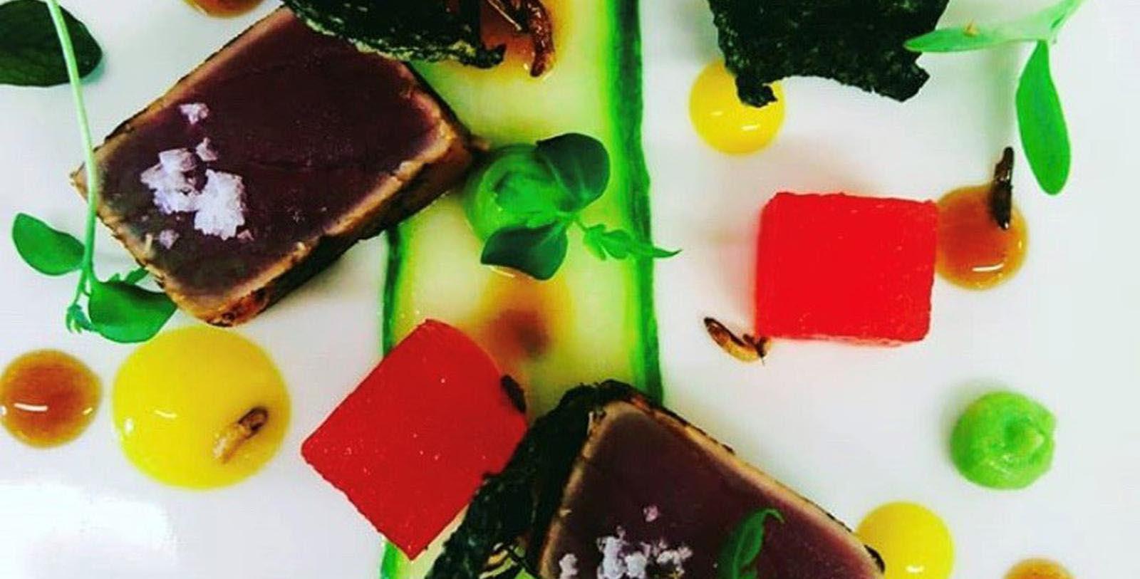 a plate of food with different colored food items