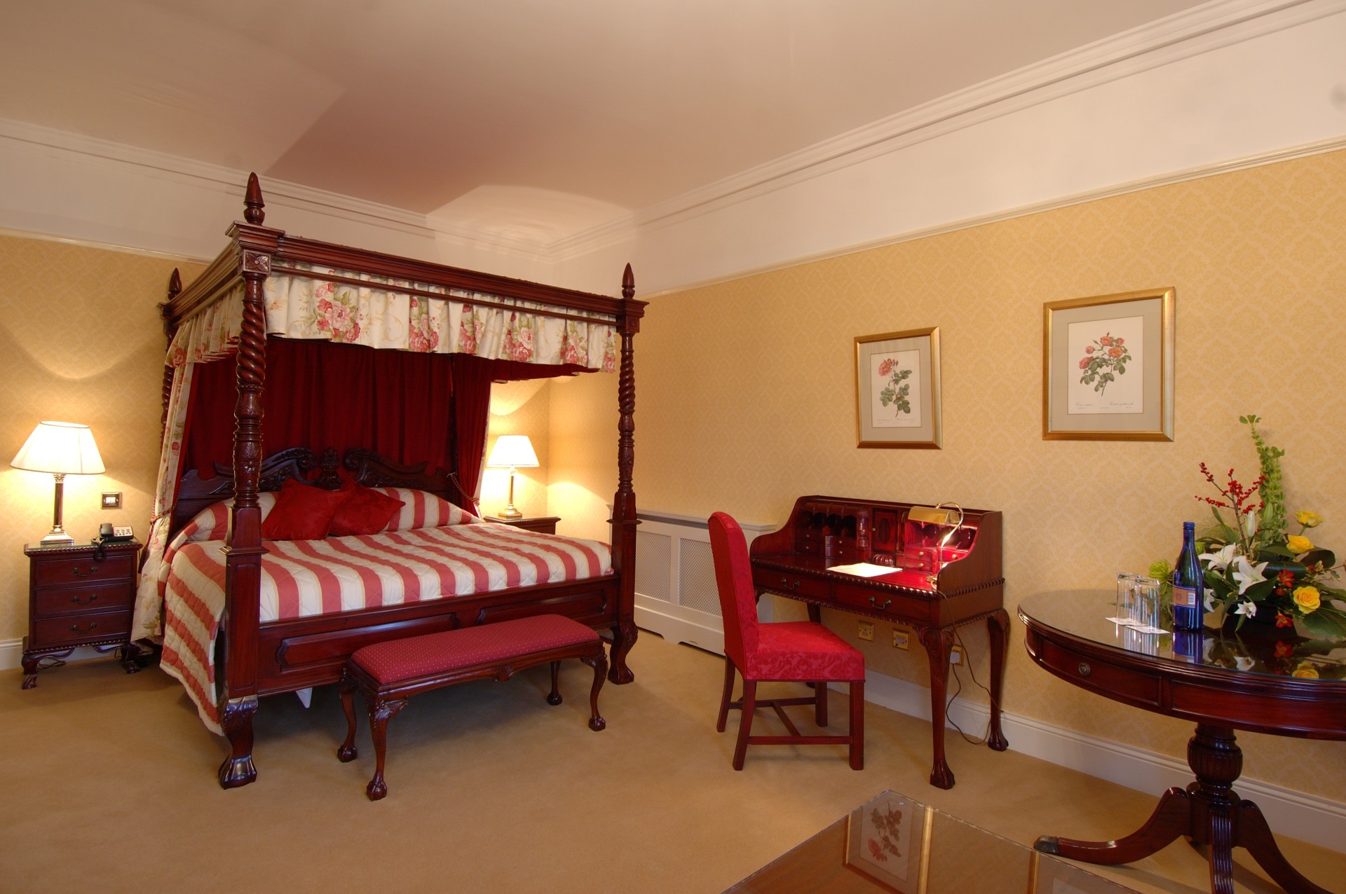 a bedroom with a four poster bed and a desk