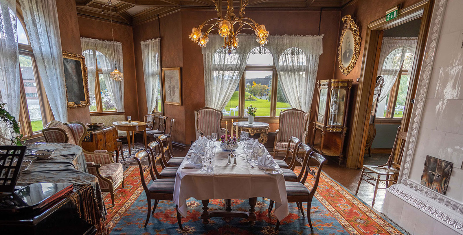 a dining room with a table set and chairs