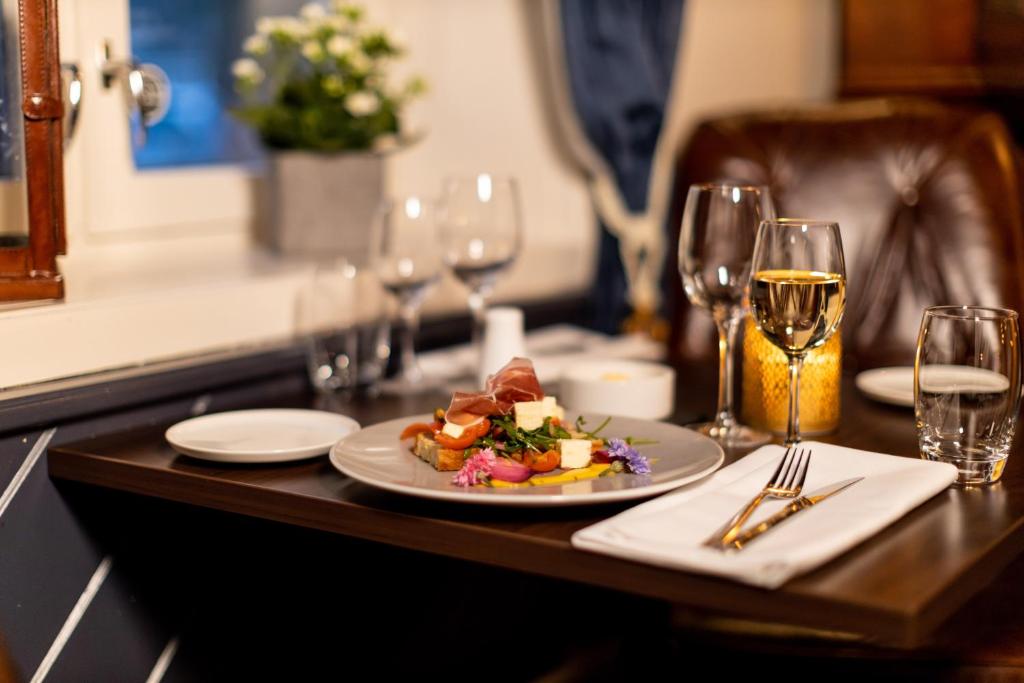 a plate of food and wine glasses on a table
