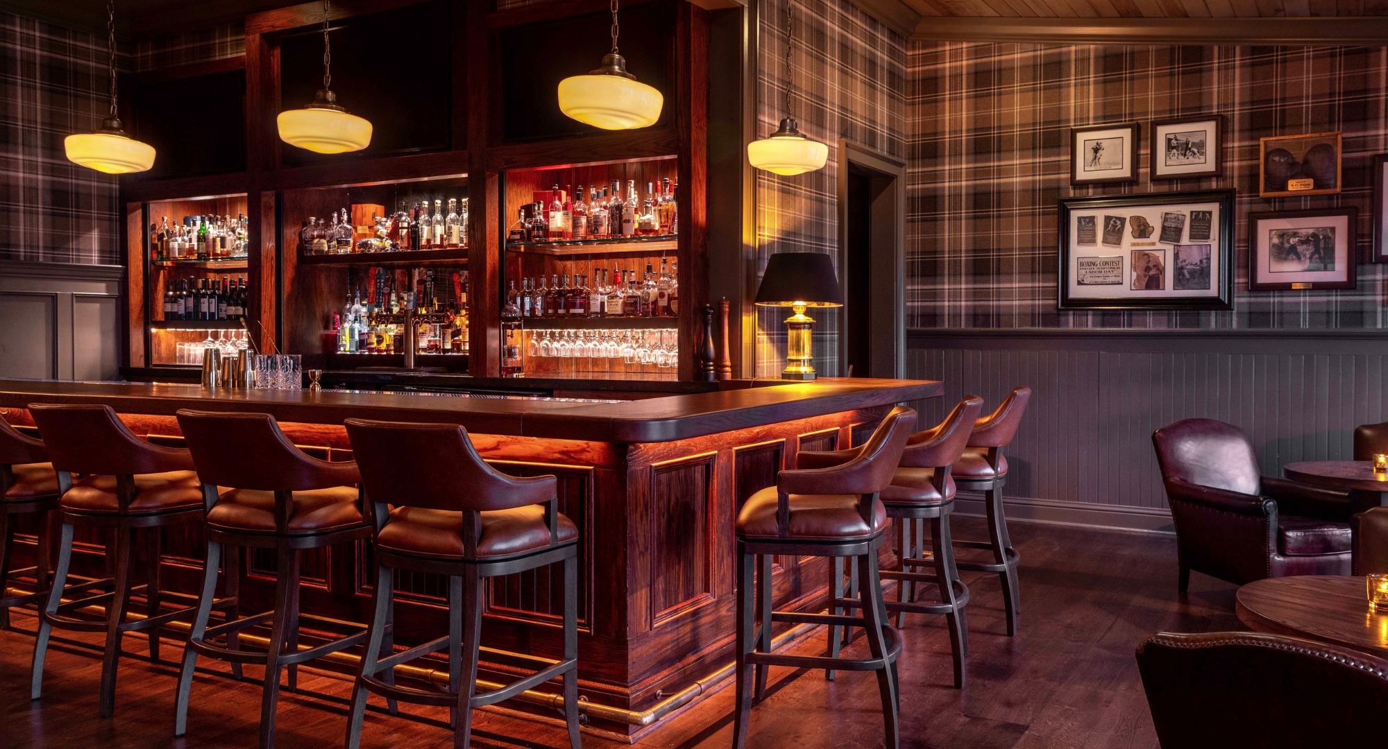 a bar with a shelf of liquor and a lamp
