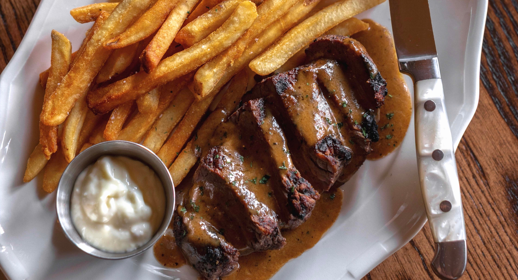 a plate of steak and french fries