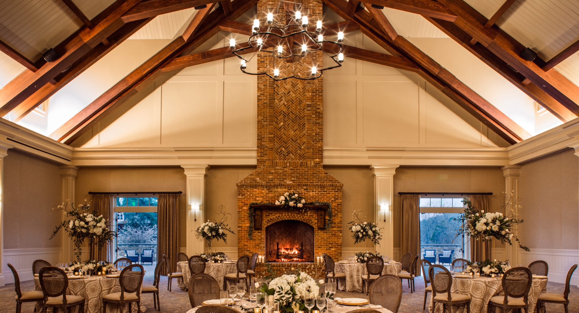 a room with a fireplace and tables
