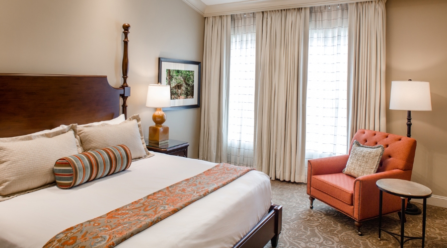 a bedroom with a bed and a chair
