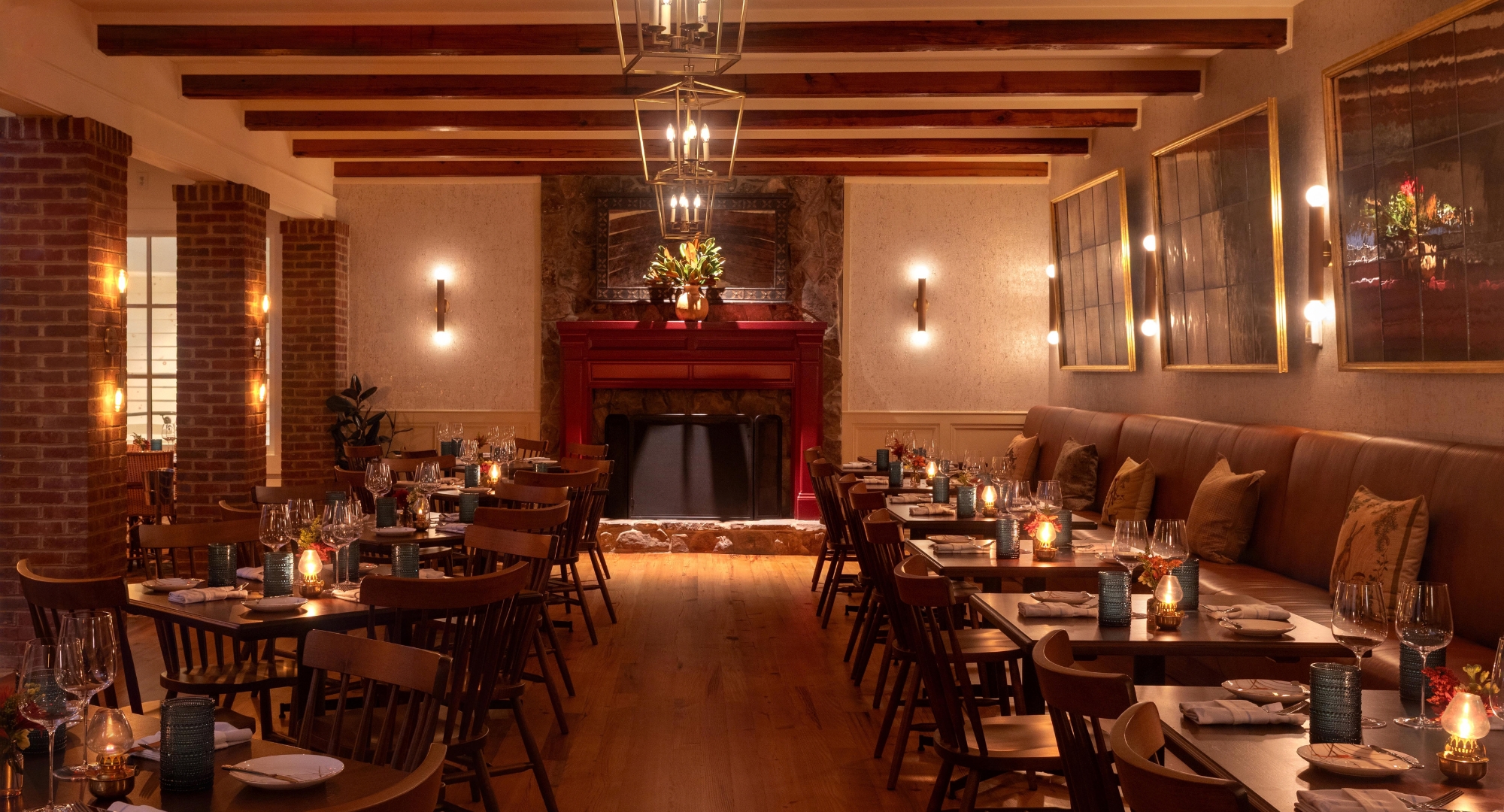 a room with tables and chairs and a fireplace