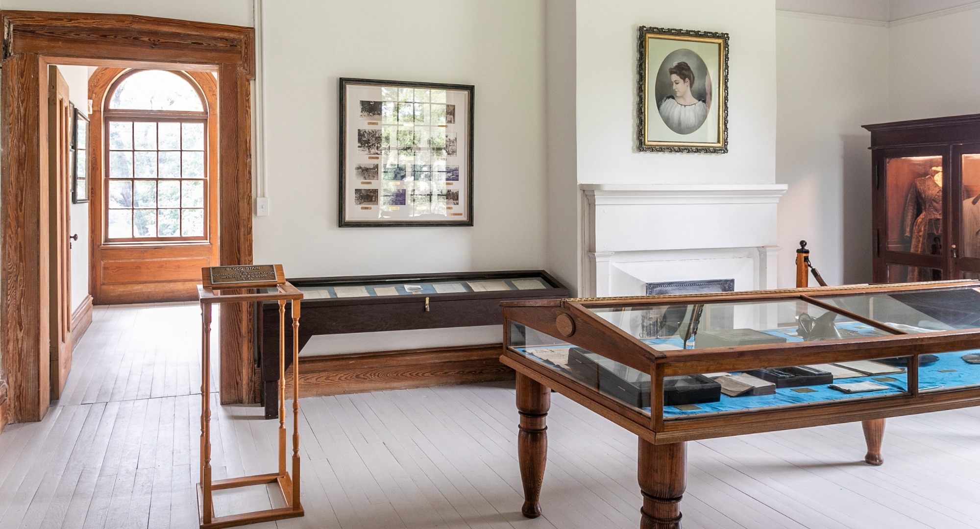 a room with a fireplace and a glass case
