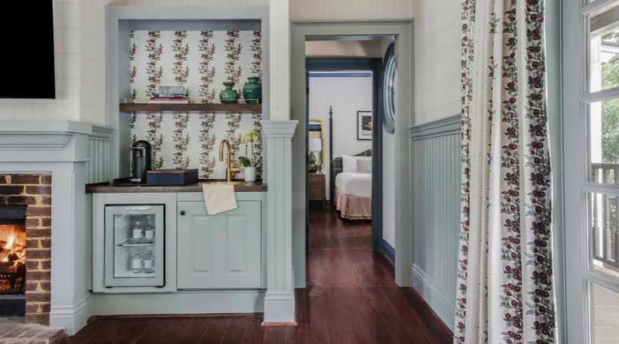 a kitchen with a wood floor and a bed