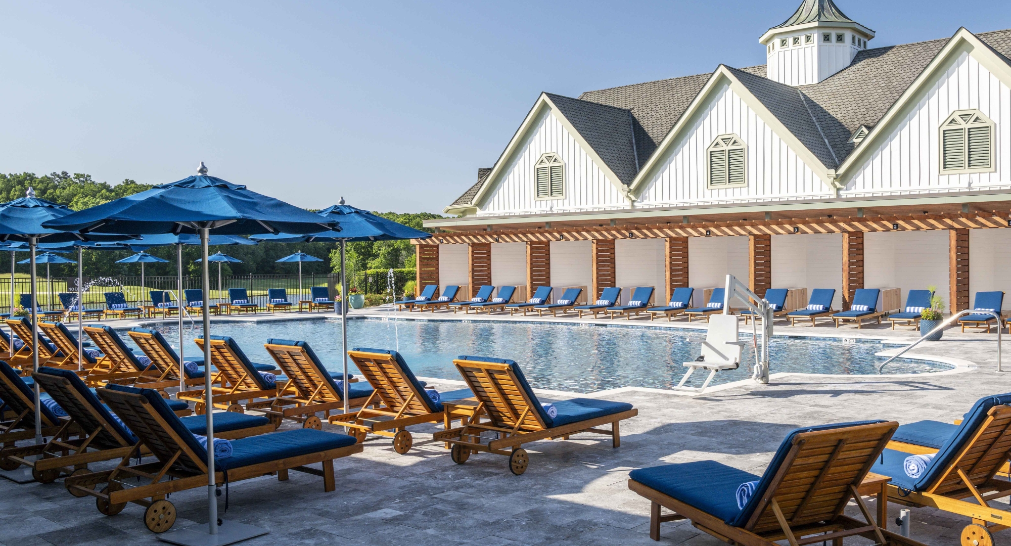 a pool with chairs and umbrellas