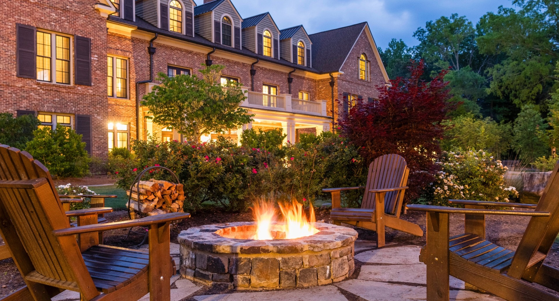 a fire pit in front of a large building