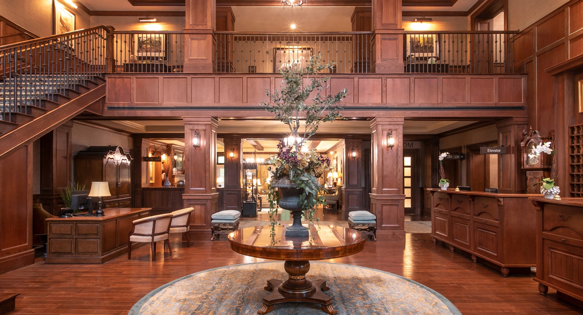 a large round table in a room with a large tree in it