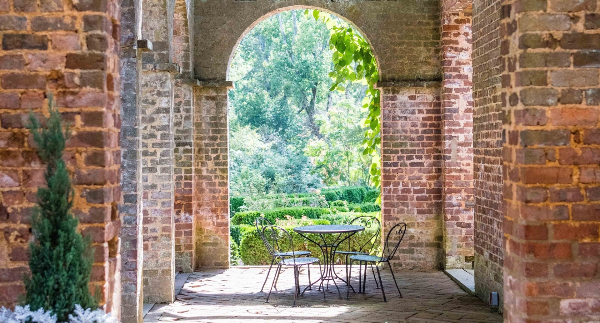 a table and chairs in a brick building