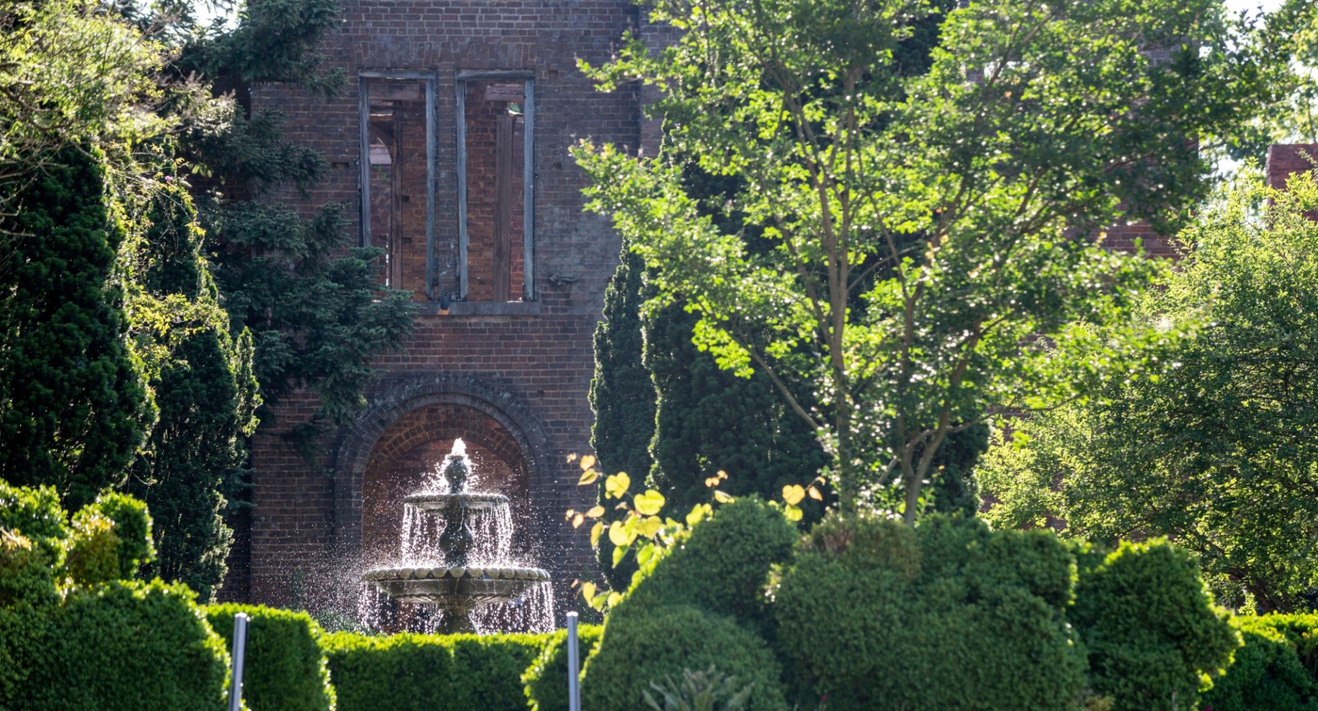a fountain in front of a brick building