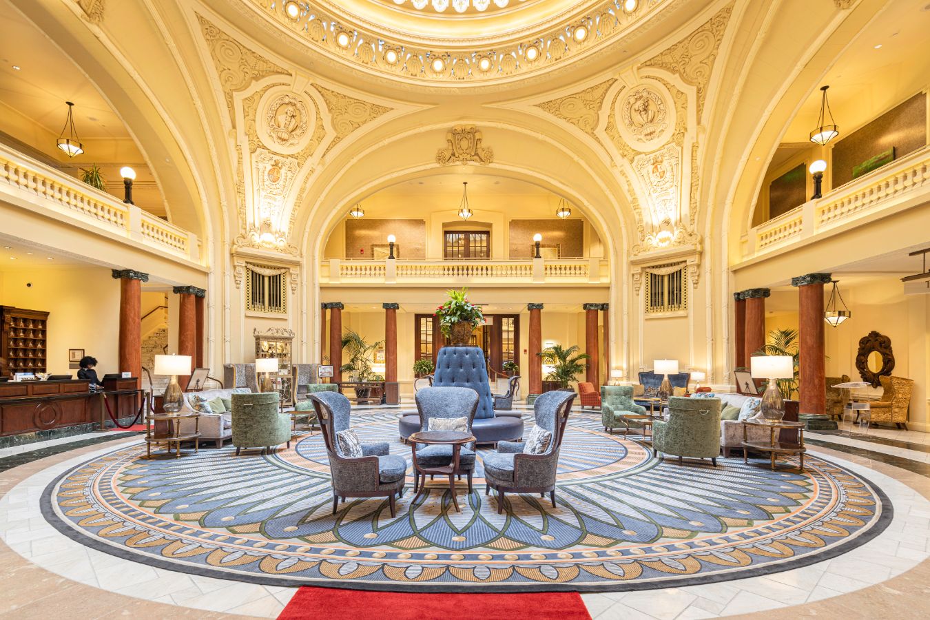 a large room with a circular area with chairs and a large ceiling