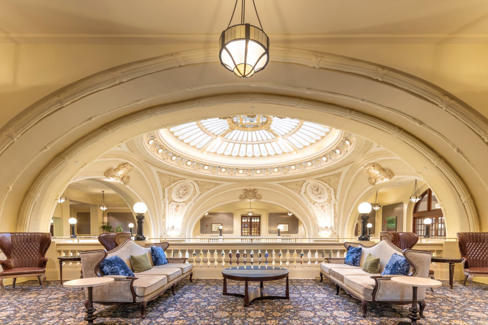 a room with a round table and couches