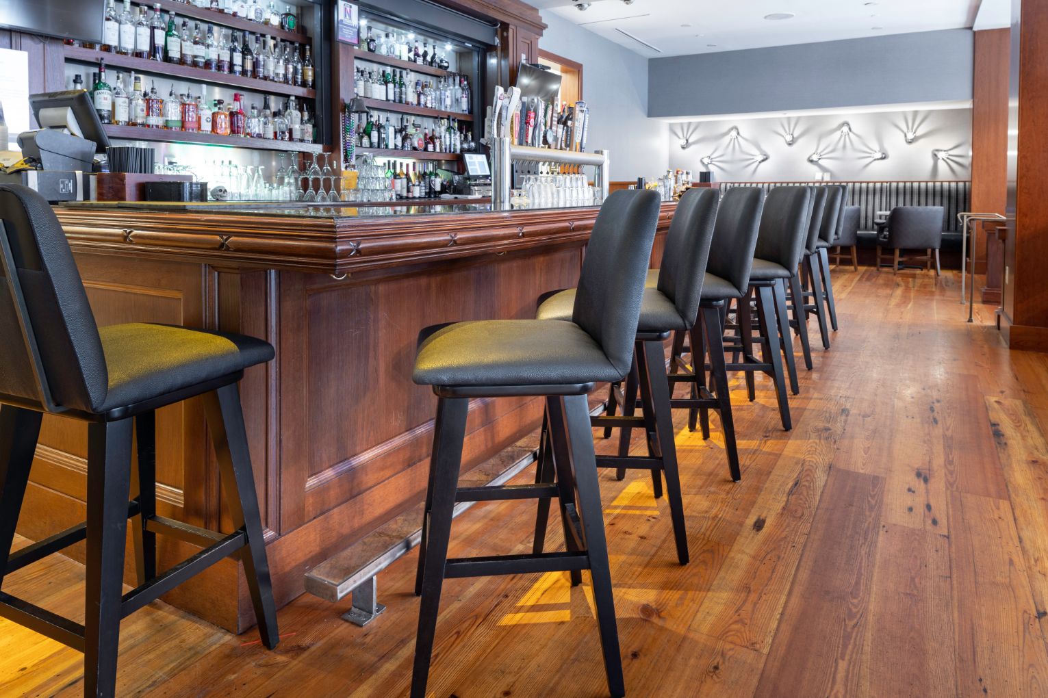 a row of chairs in a bar