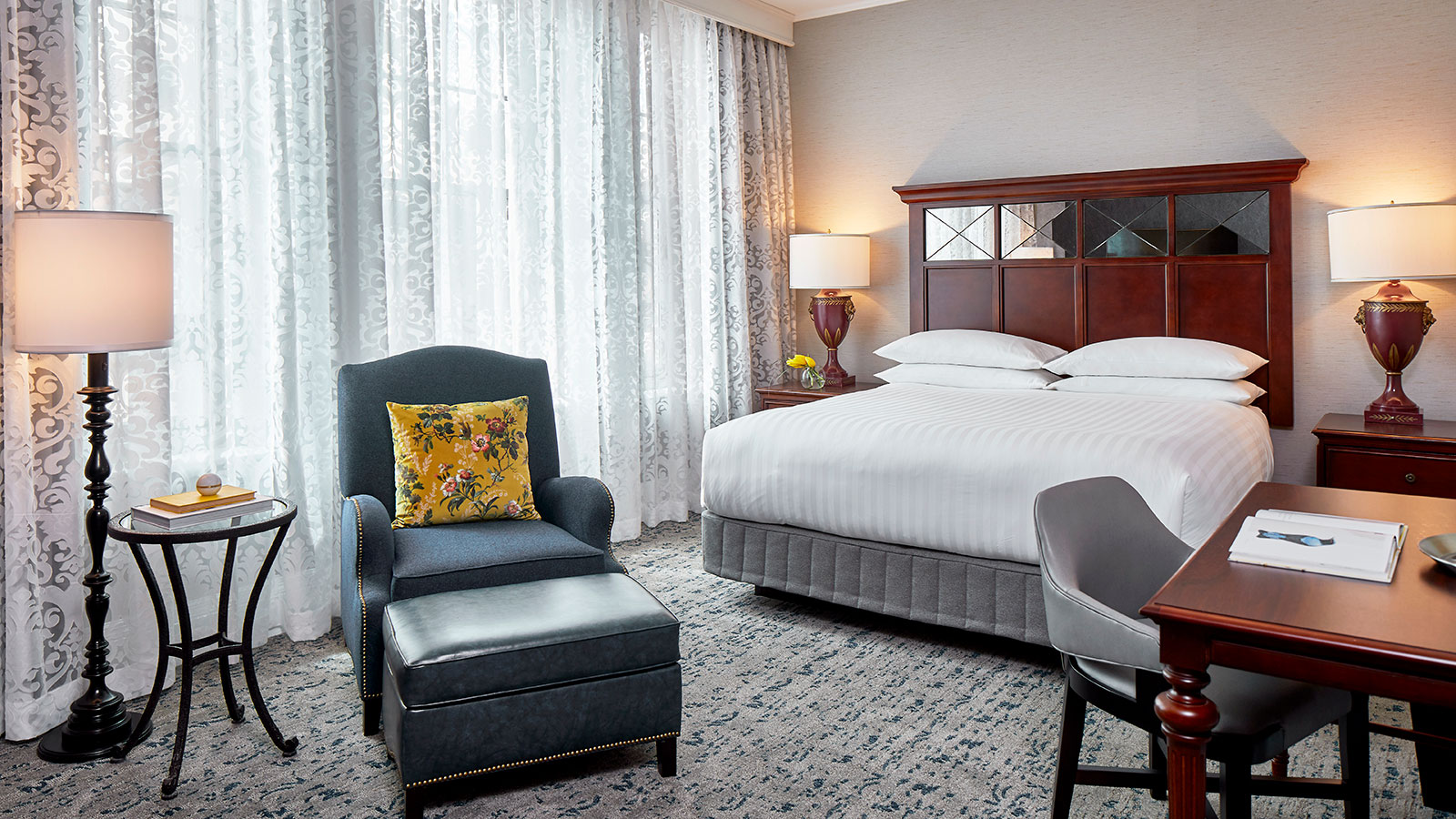 a bedroom with a bed and chair