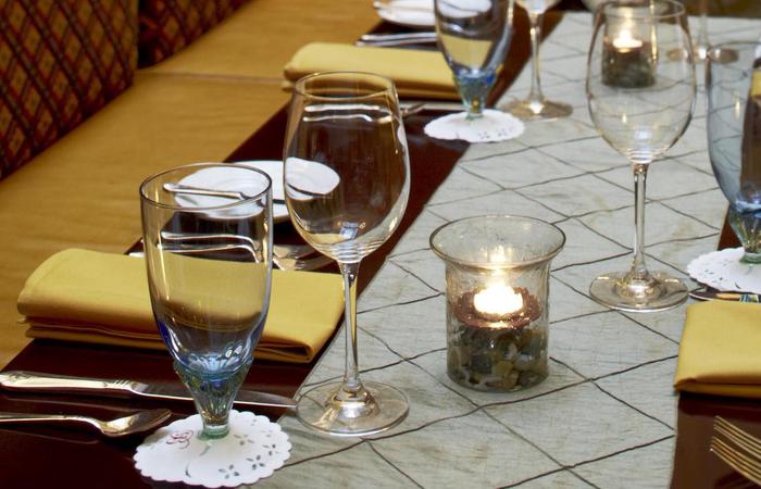 a table with wine glasses and candles