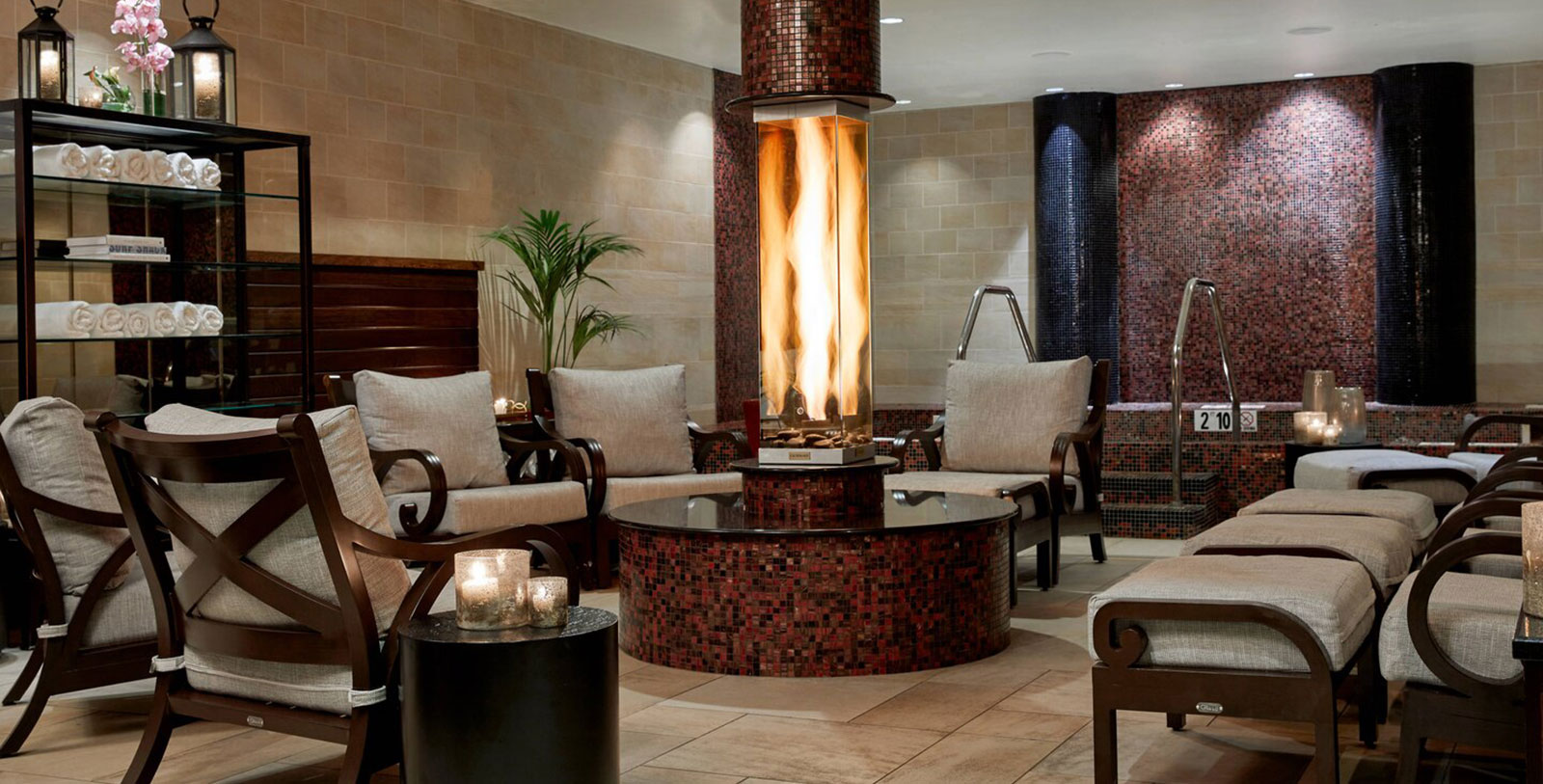 a room with a fireplace and chairs
