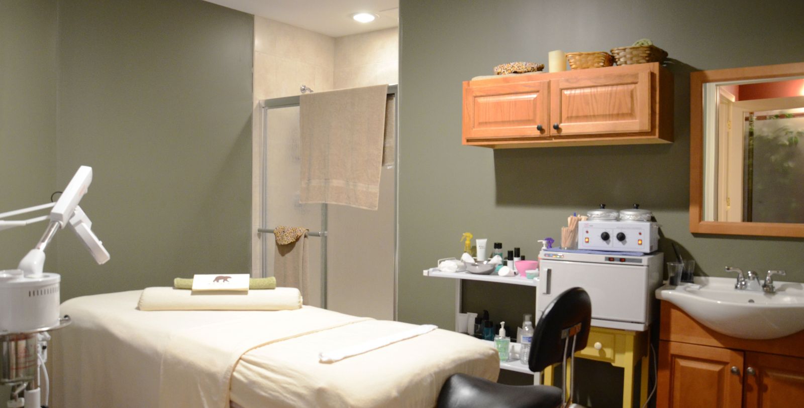 a massage room with a towel on a bed