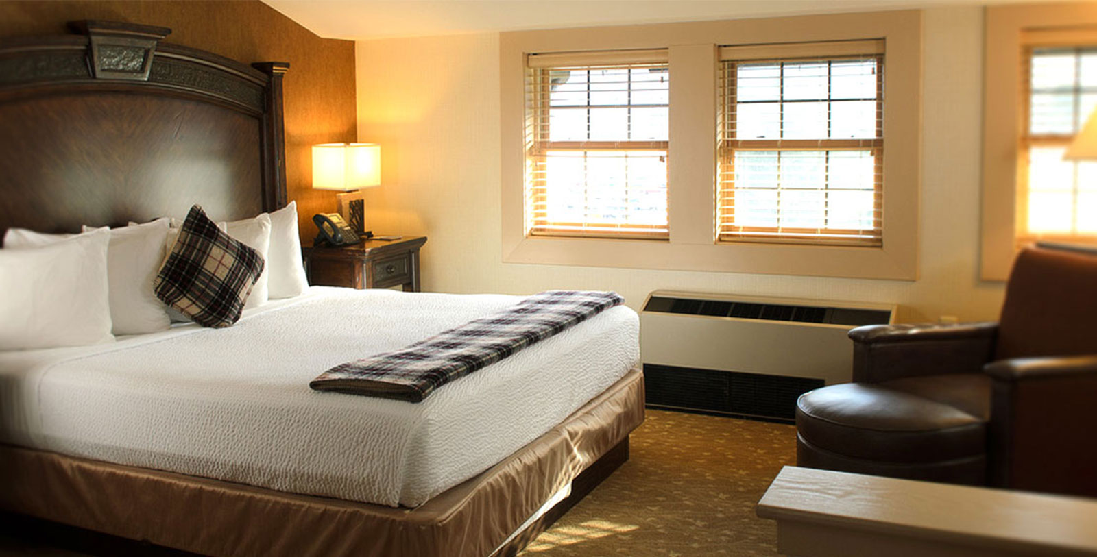 a hotel room with a bed and a heater