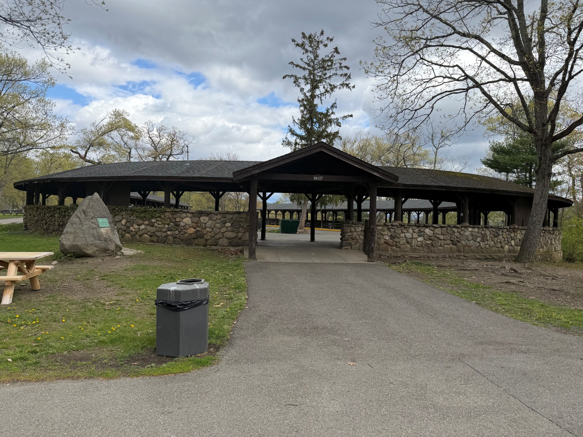 a covered area with a stone wall and a large stone wall