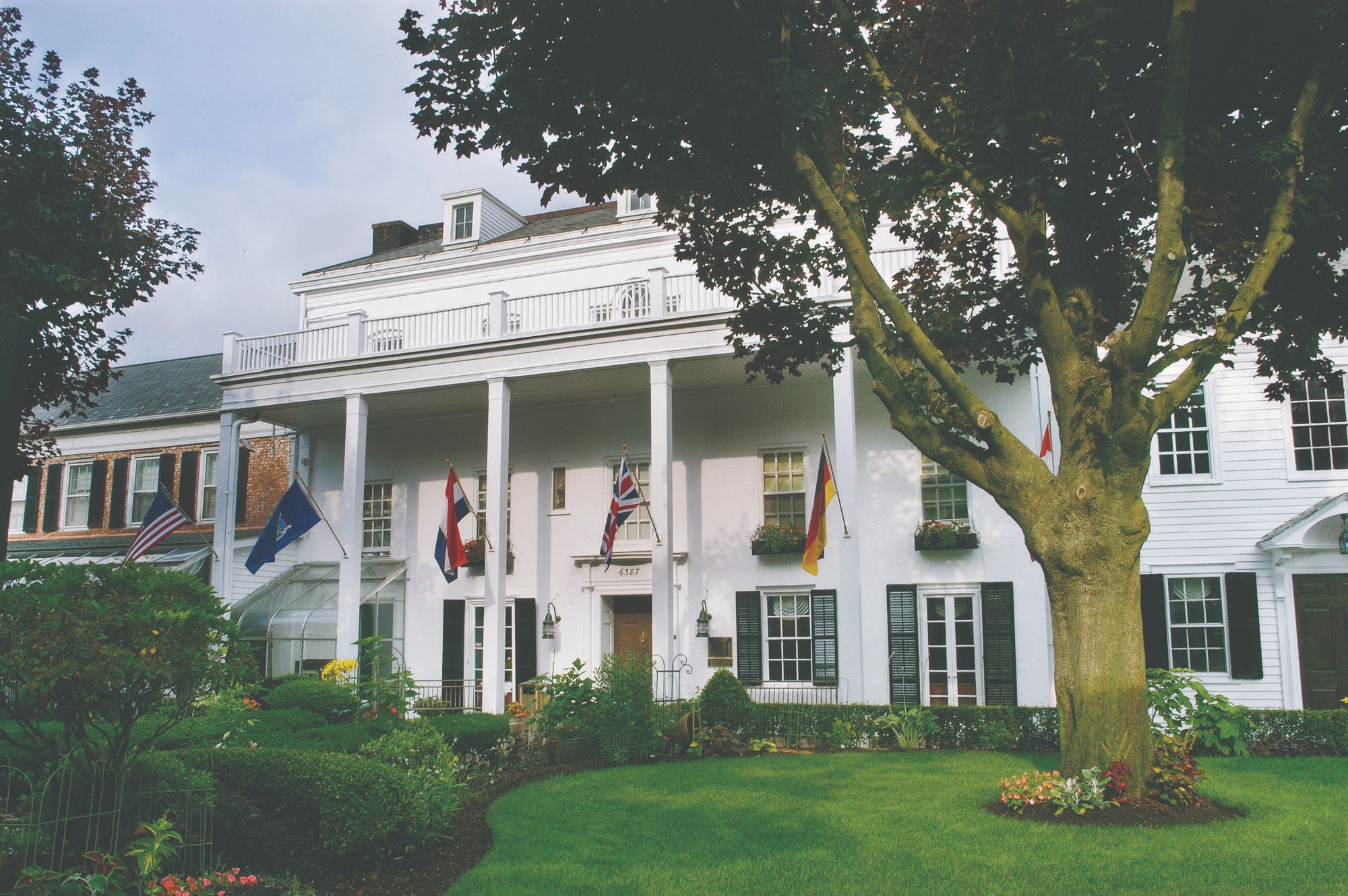 a white house with flags in front of it