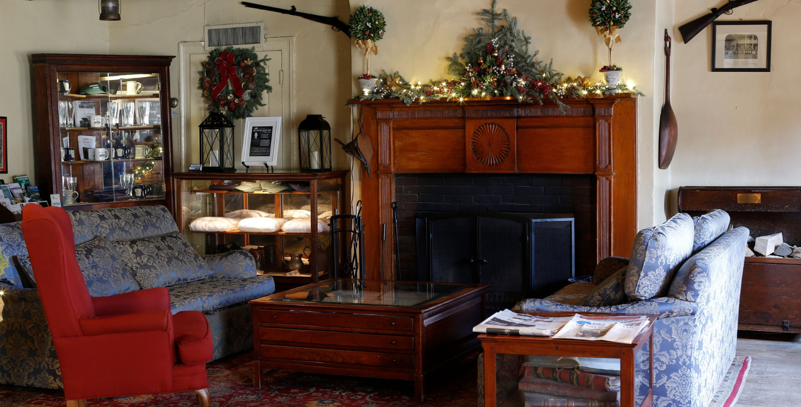 a room with a fireplace and christmas decorations