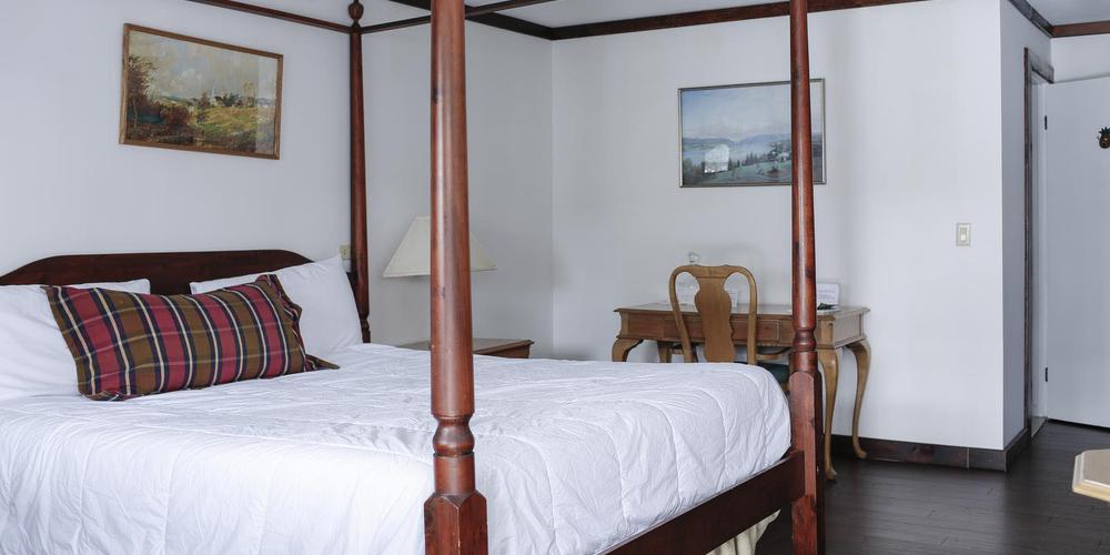 a bed with a four poster bed