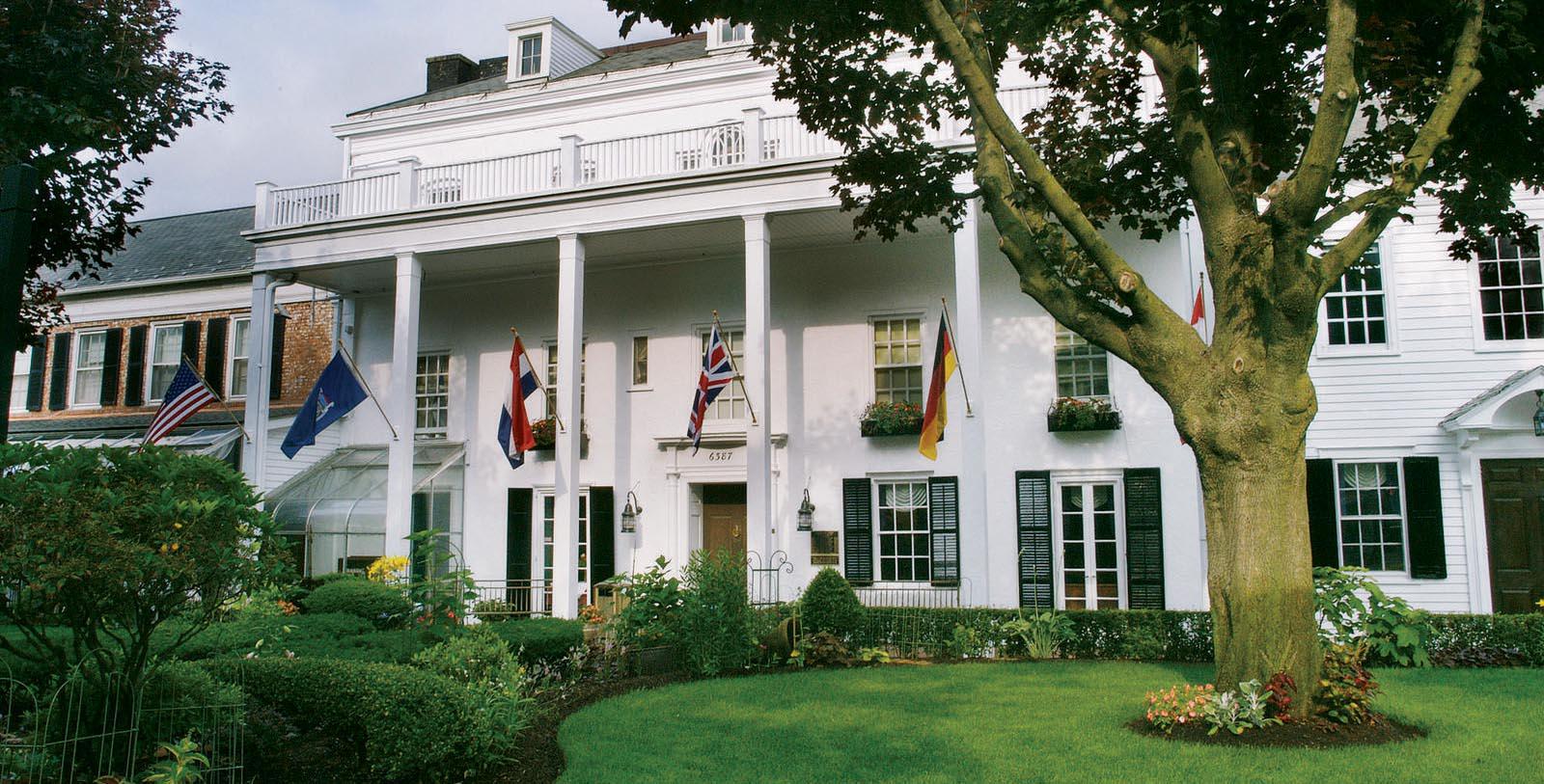 a white house with flags on the front