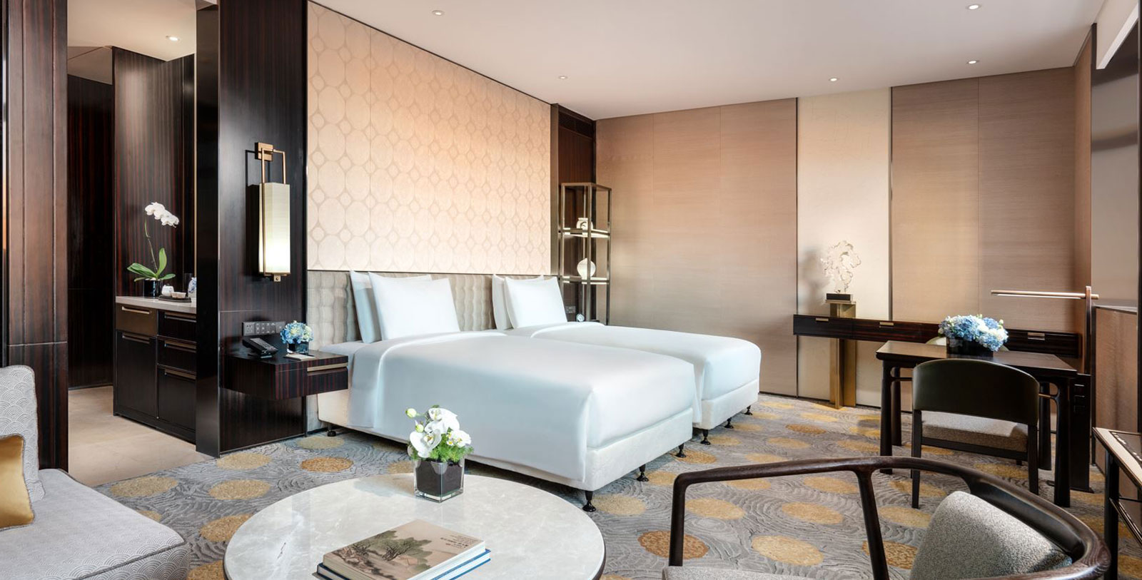 a room with two beds and a table
