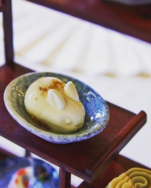 a white bunny shaped food in a blue bowl