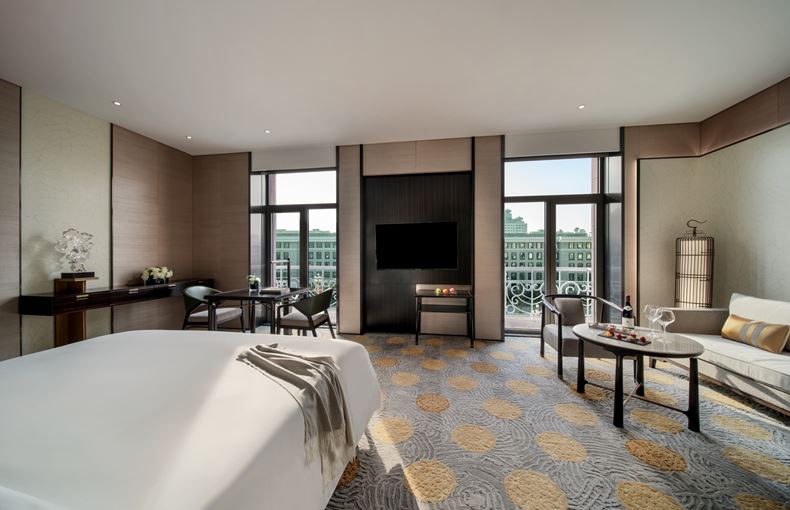 a room with a bed and a television