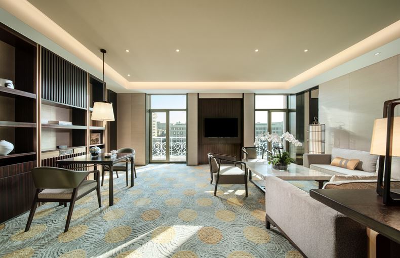 a room with a tv and chairs