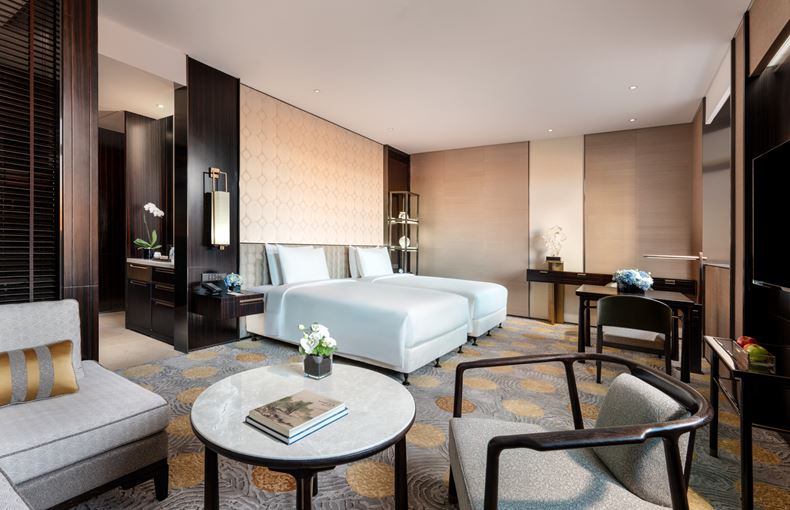 a room with two beds and a table