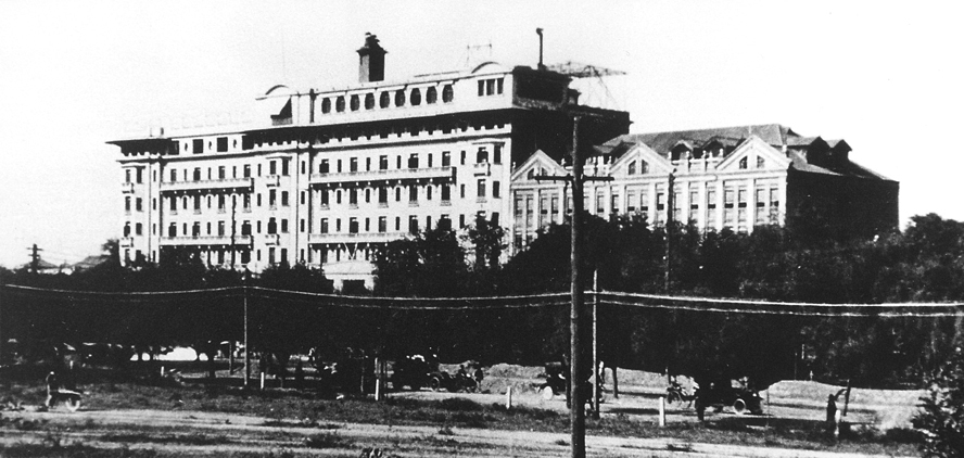 a large building with trees in the background
