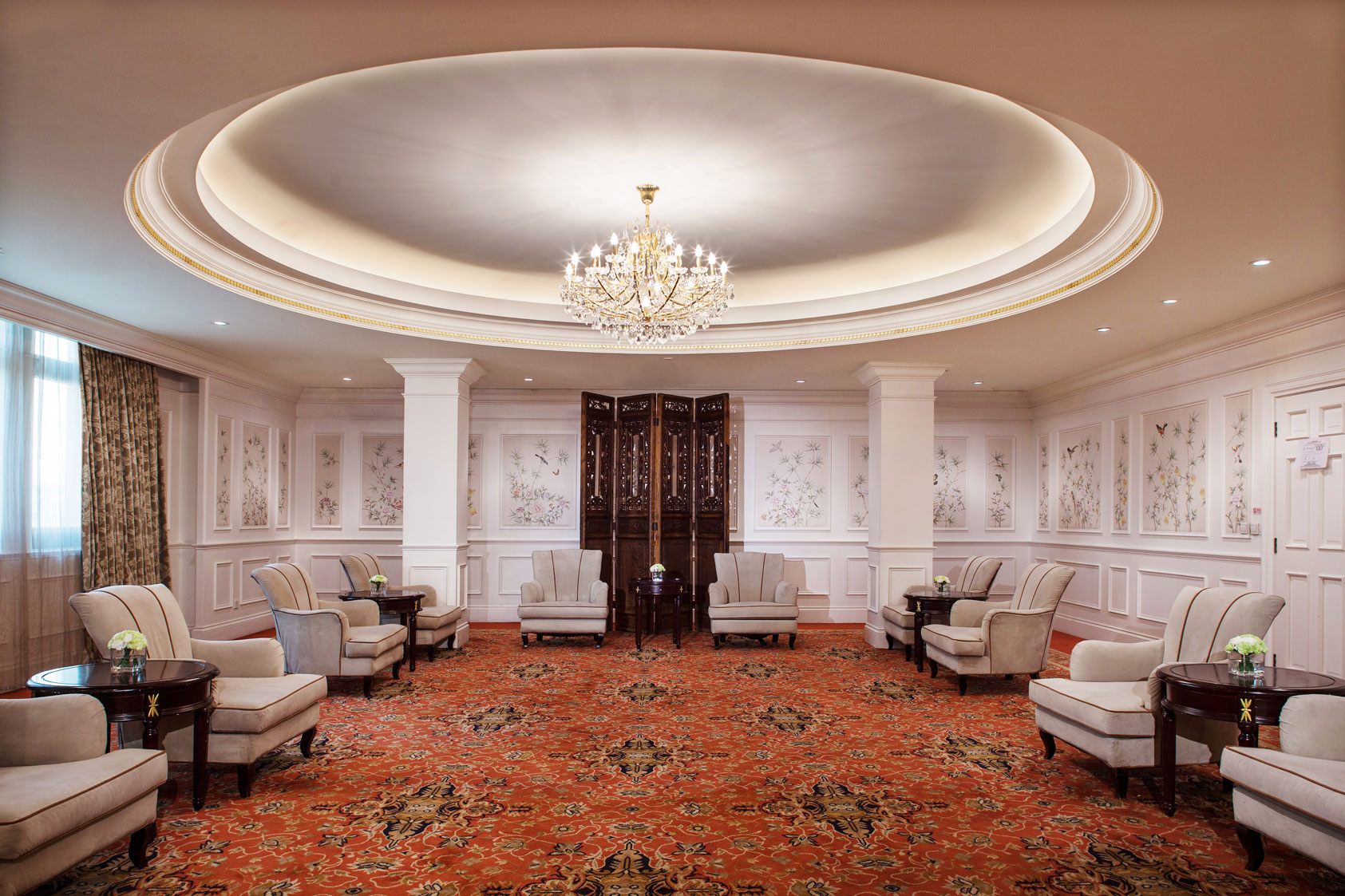 a room with chairs and a chandelier