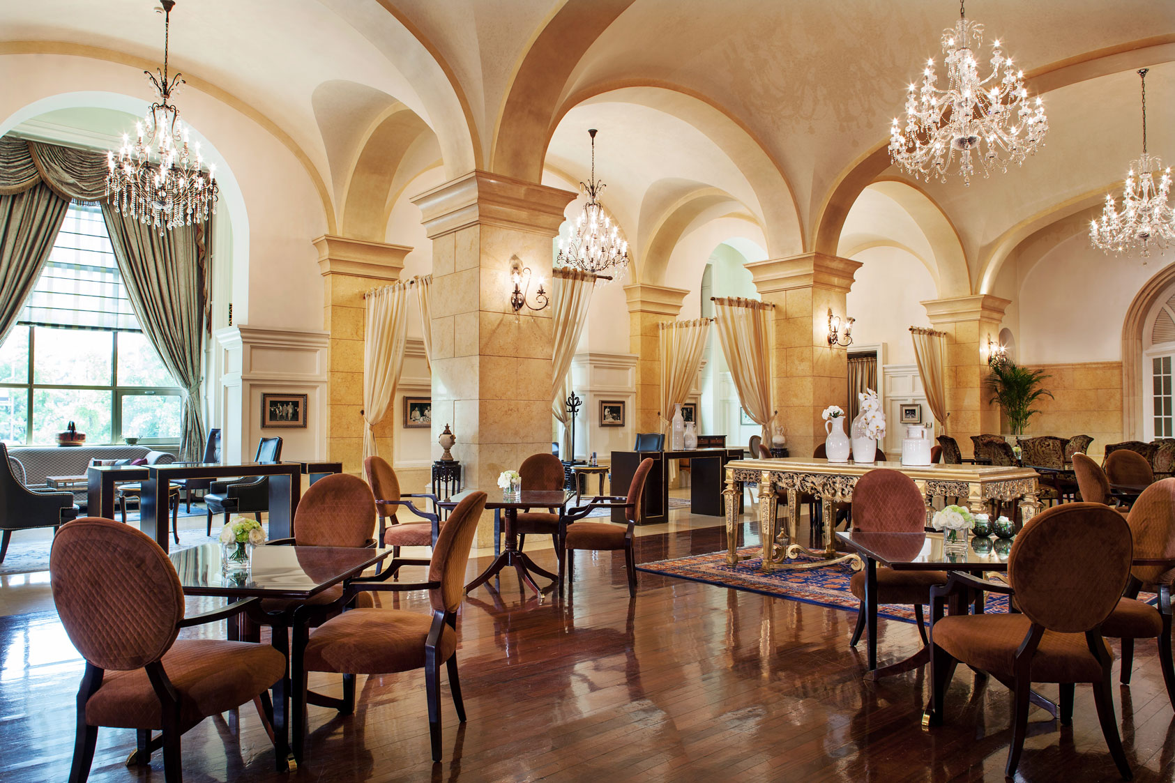 a room with a chandelier and tables