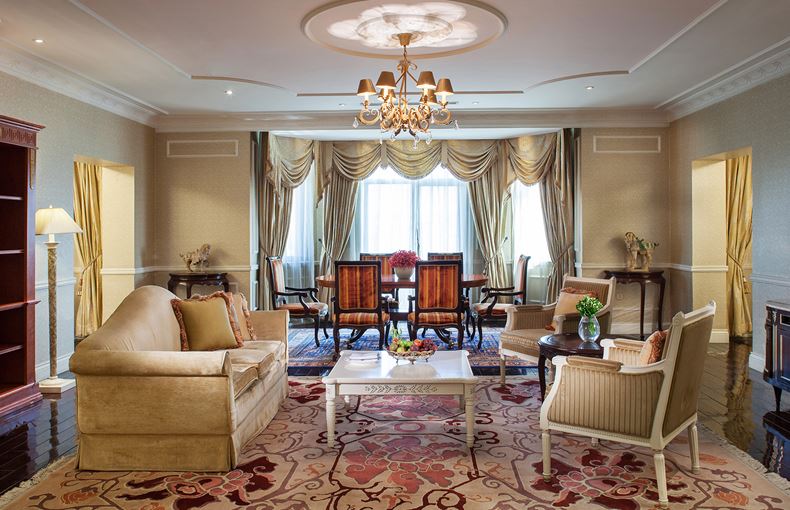 a room with a chandelier and chairs