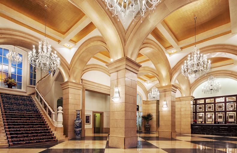 a large hall with chandeliers and stairs