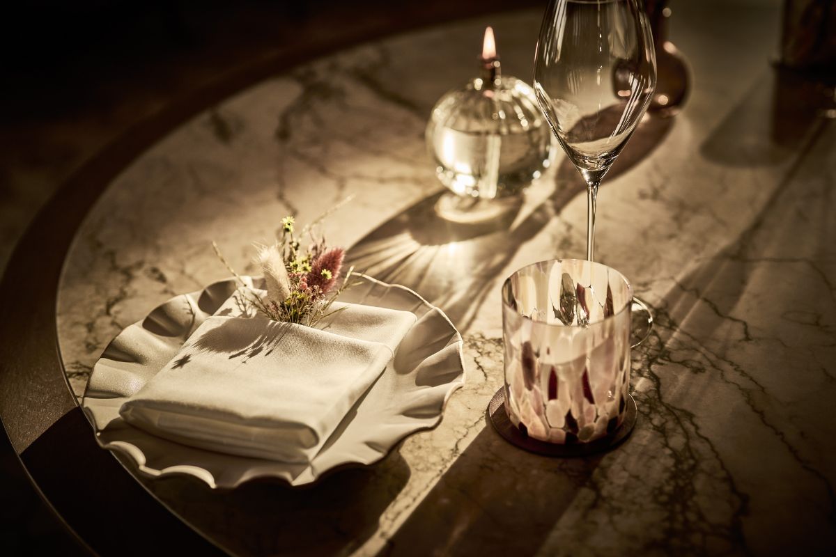 a table with a napkin and a candle