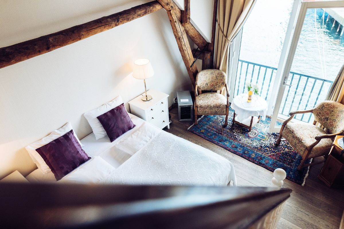 a room with a bed and chairs and a table