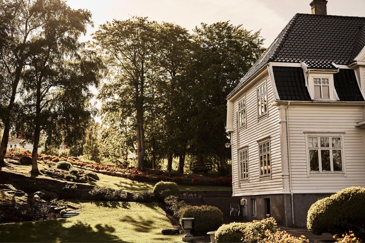 a house with a lawn and trees
