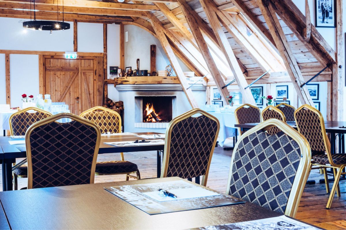 a room with a fireplace and chairs