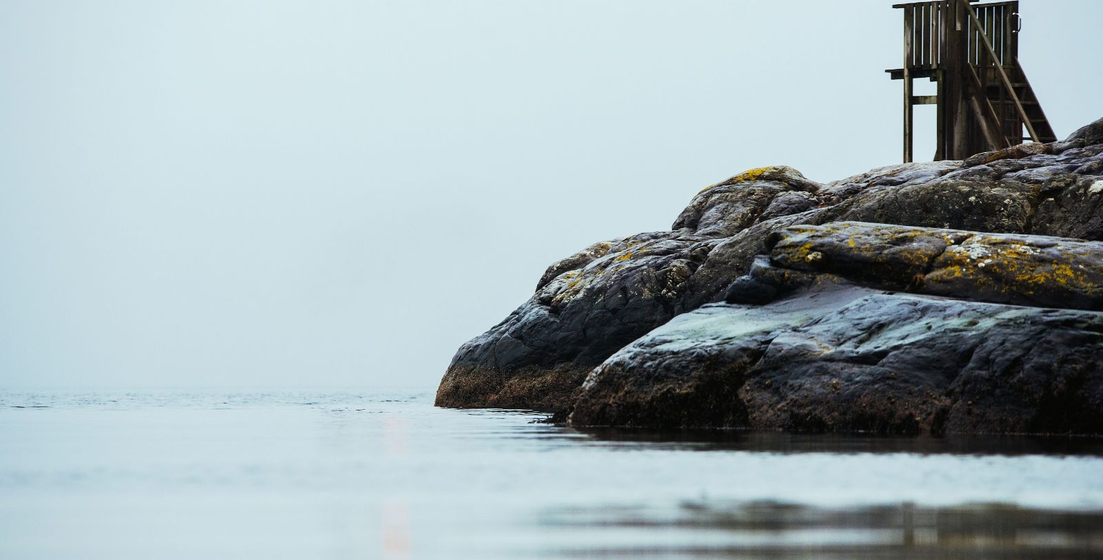 a rocky shore with water in the background