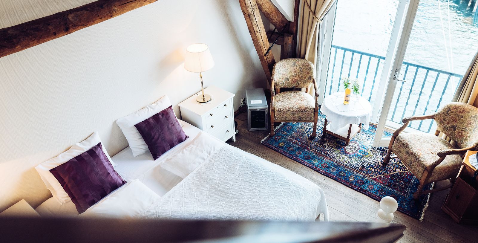 a room with a bed and a table and chairs