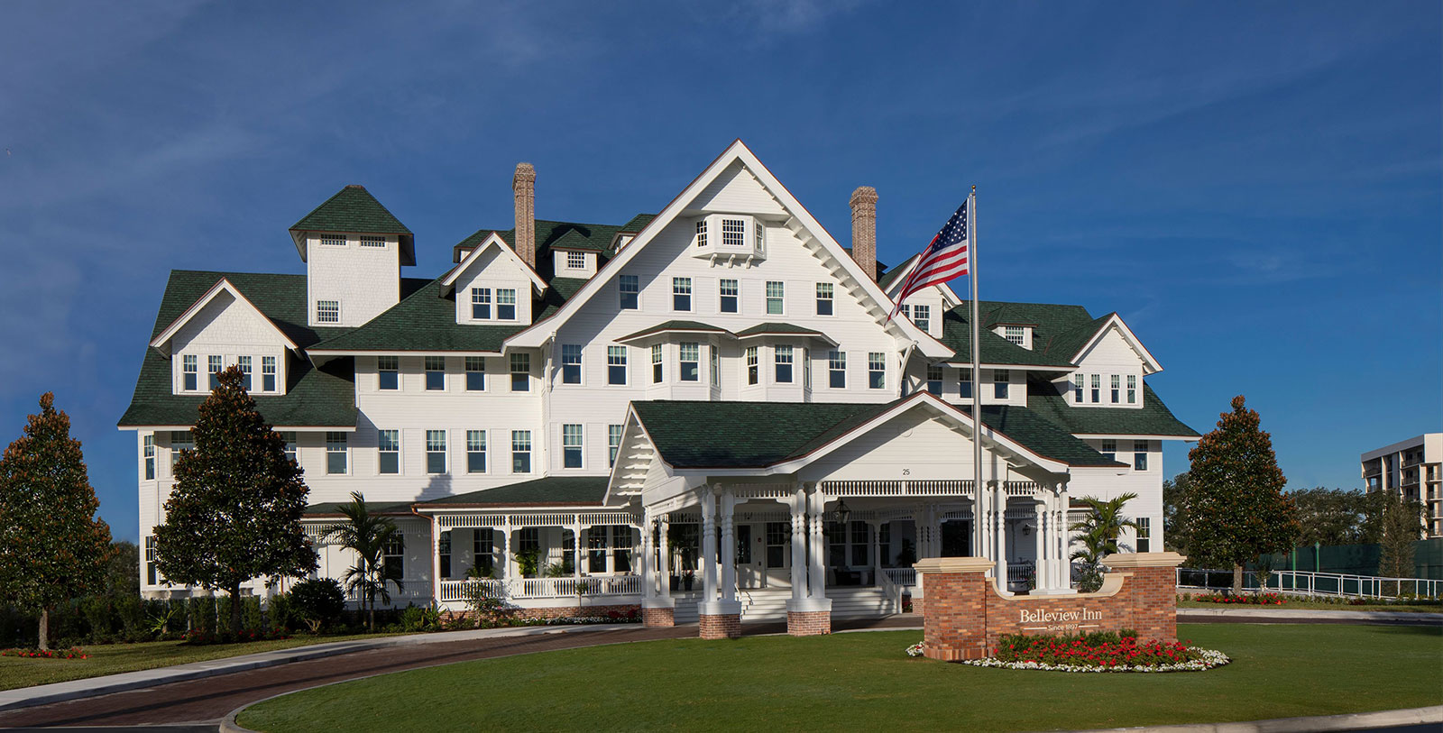 a large white building with a flag in front of it