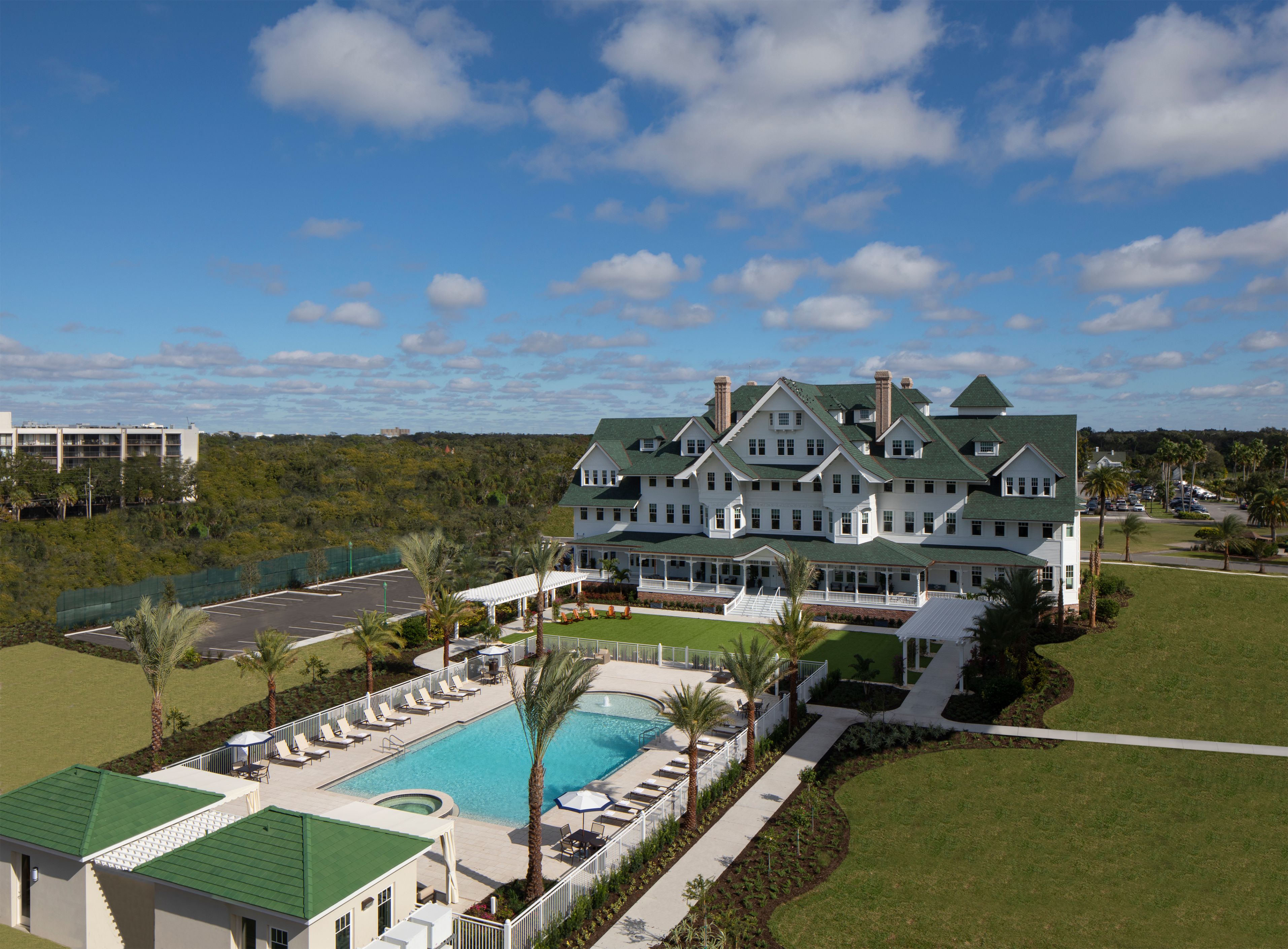 a large building with a pool and grass